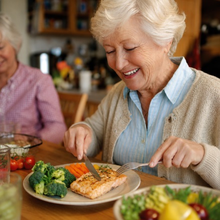 Senior enjoying a healthy meal as part of home health care in Bedford, Indiana with nutritious food and supportive in-home care environment.